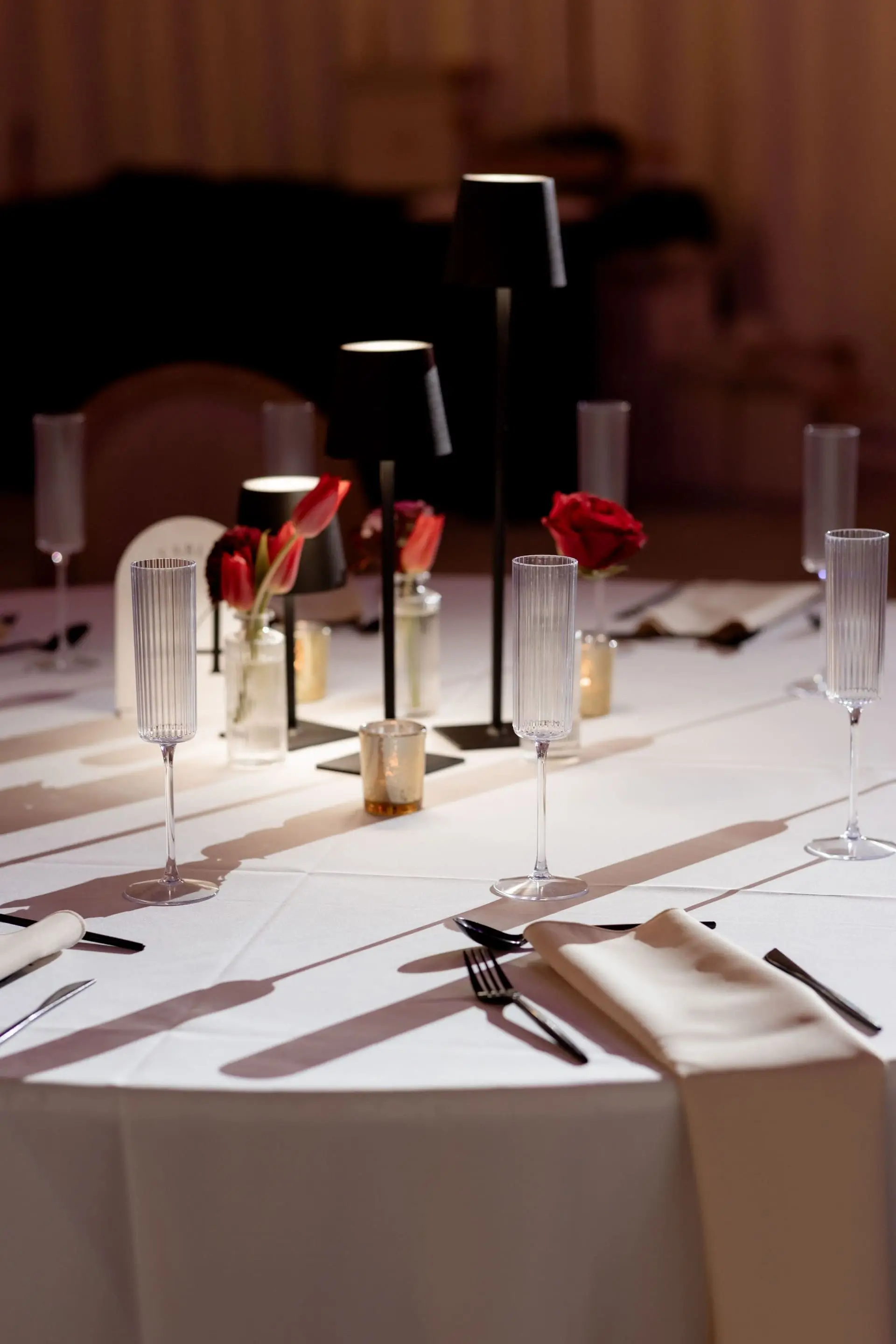 Reception detail of menu, florals, and gold flatware