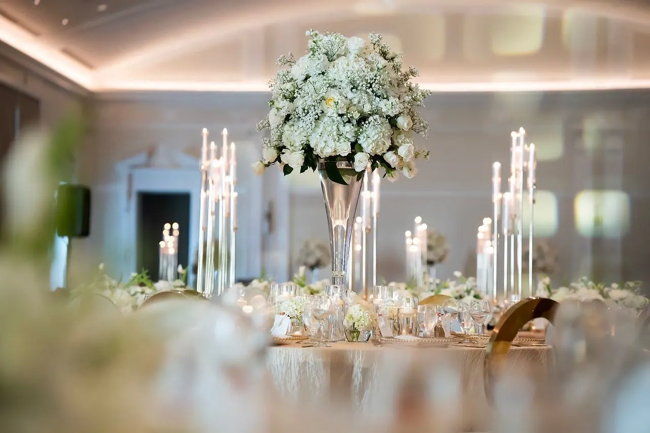 Ballroom centerpiece of white roses, hydrangea and tapered candles