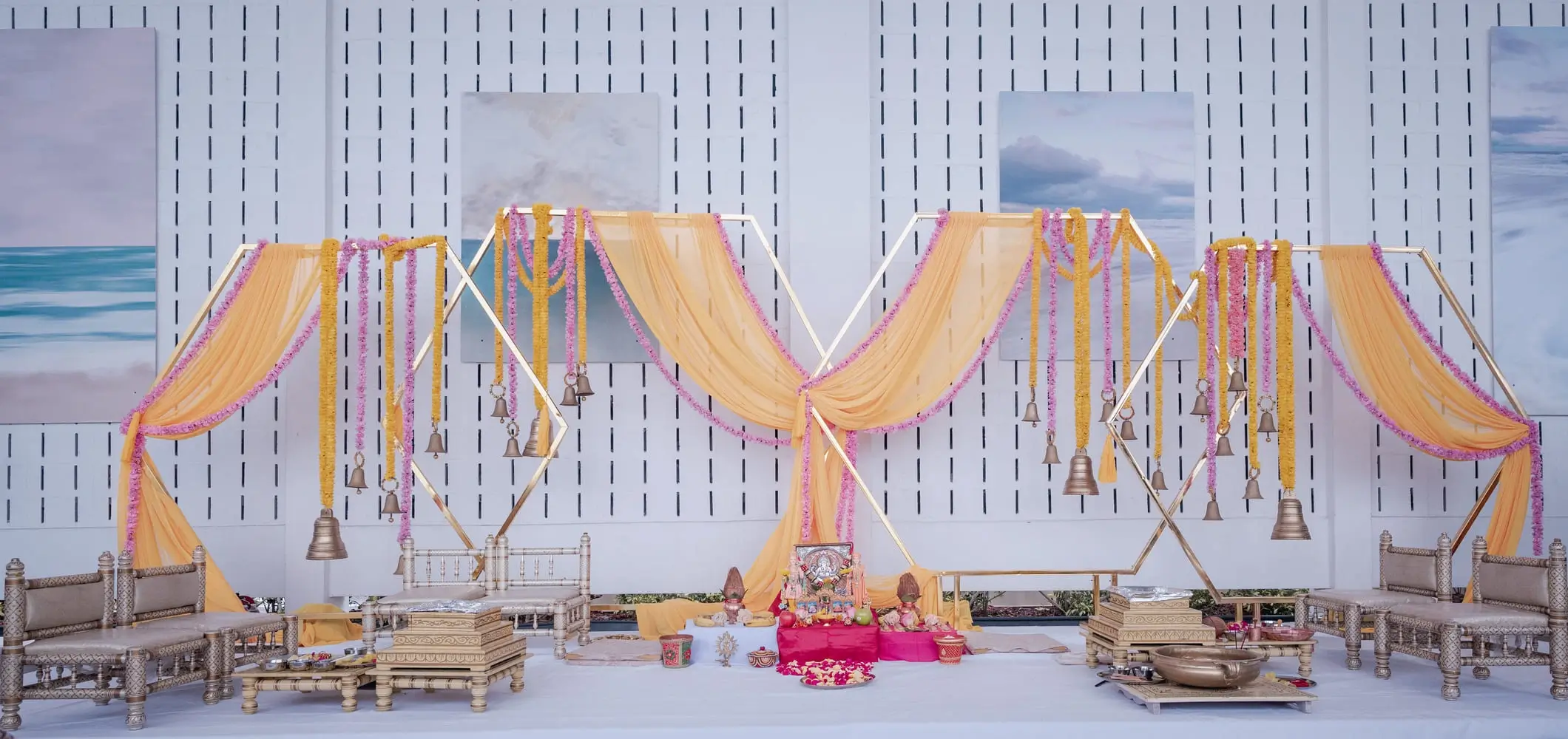 Outdoor pre-wedding ceremony under a floral canopy