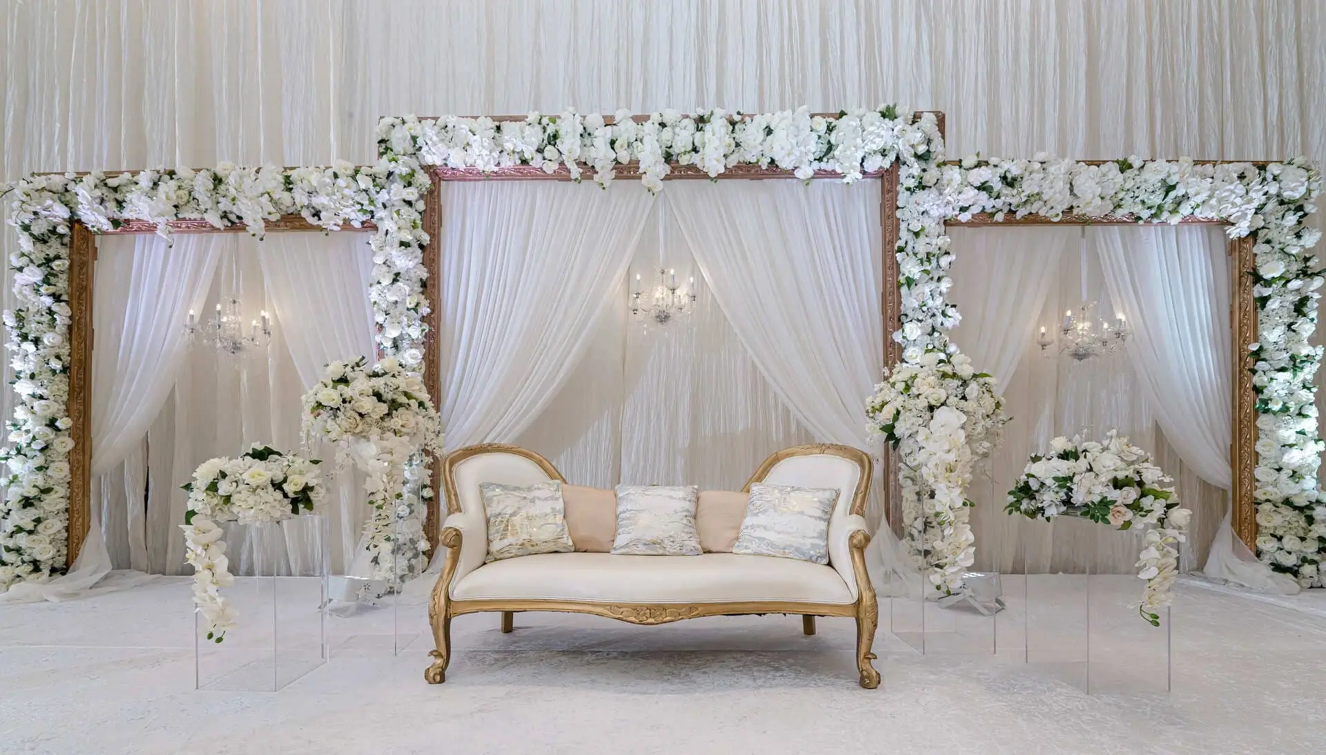 Reception lounge styled with low florals and soft amber light